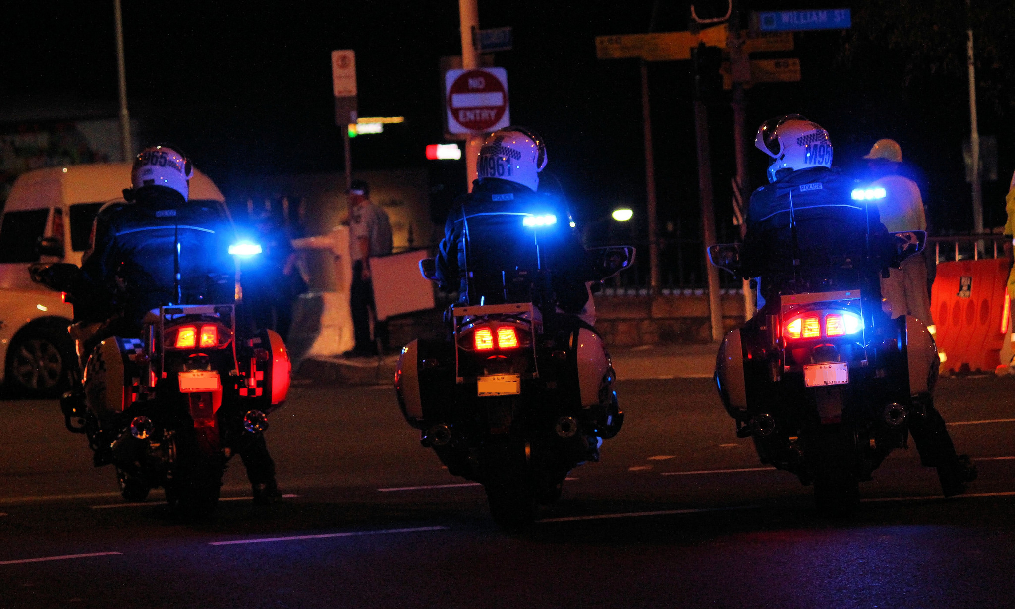 three police motorbikes at night 