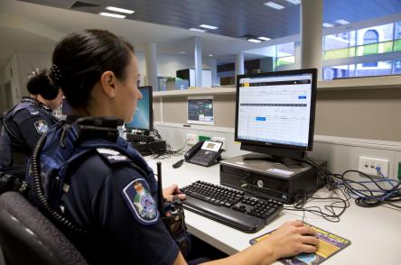 Police officer sitting at a computer