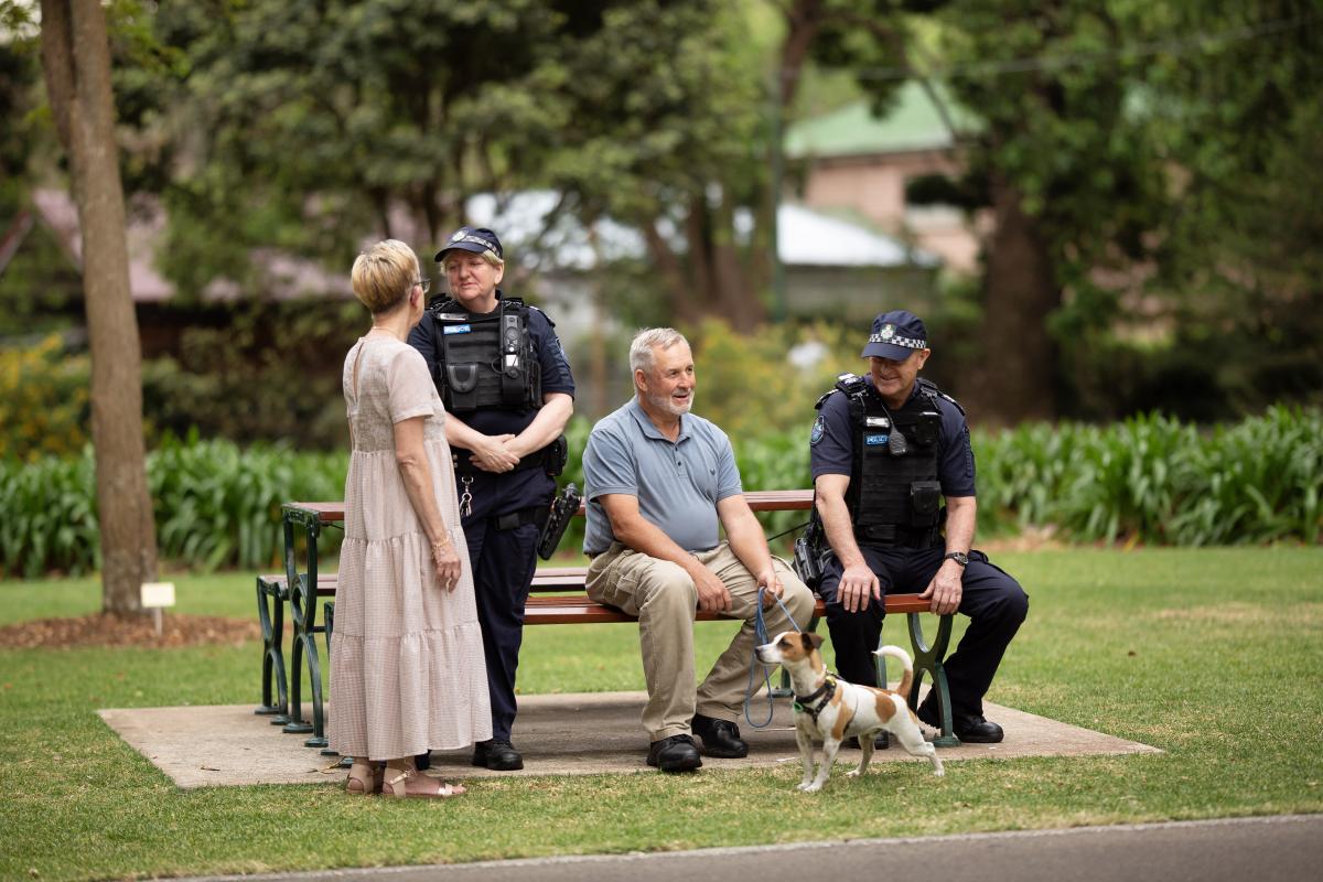 police officers talk with community in a park